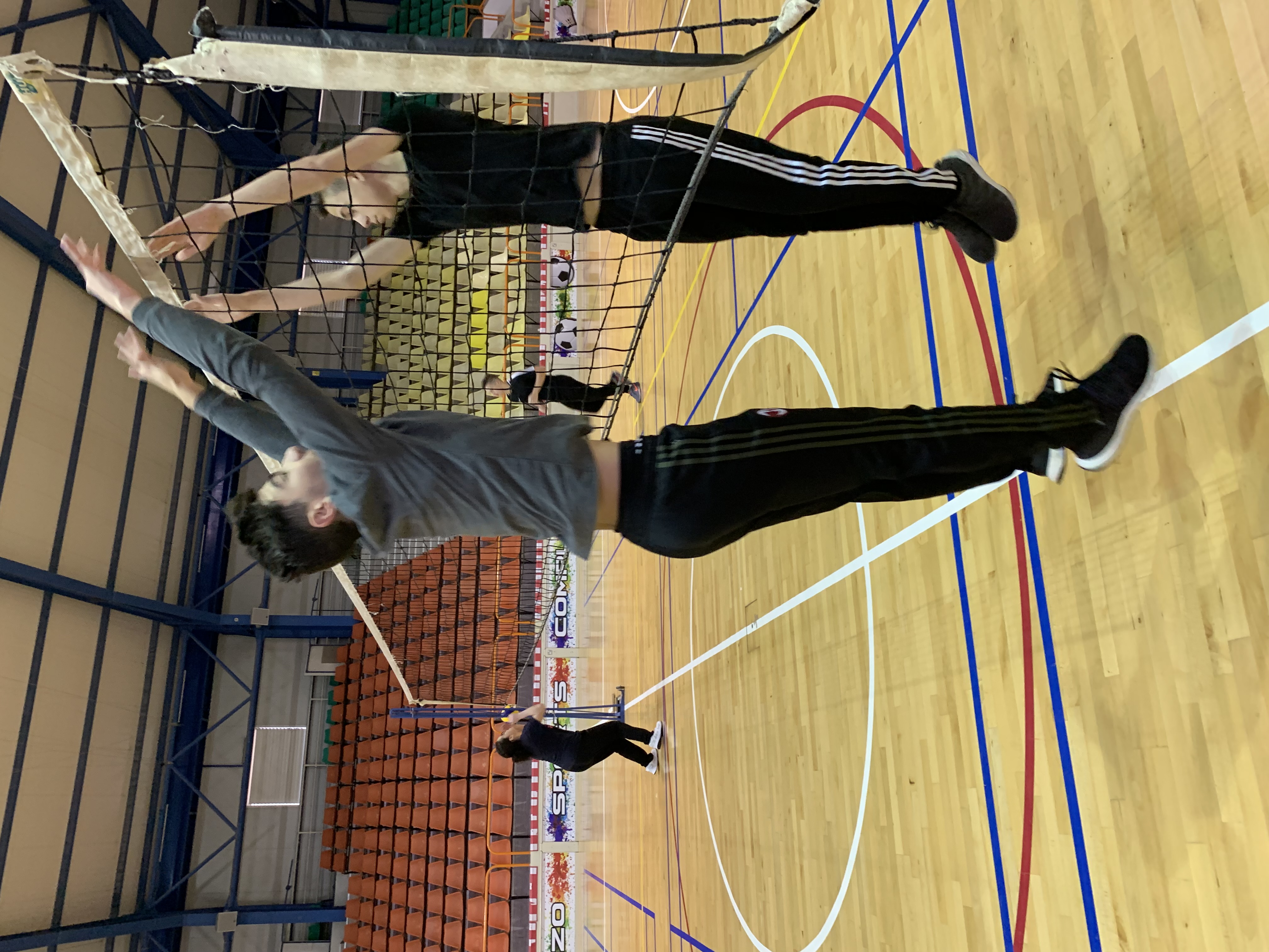 picture showing two students playing volleyball.