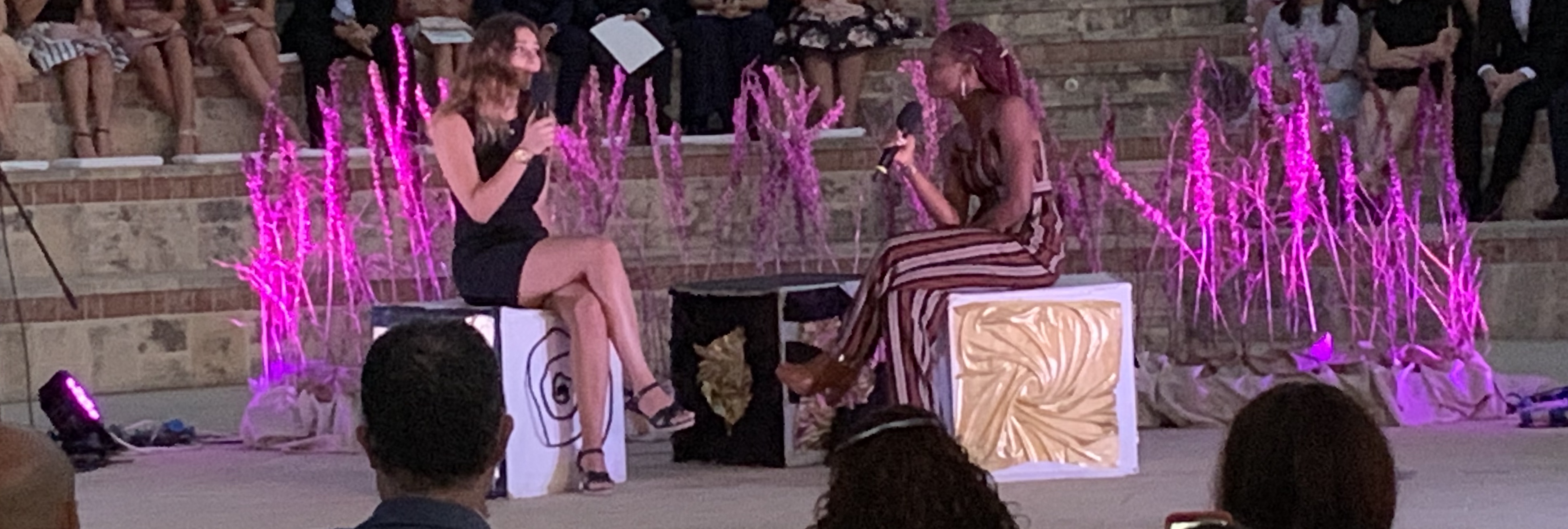 picture showing two students singing in front of each other during the performance.